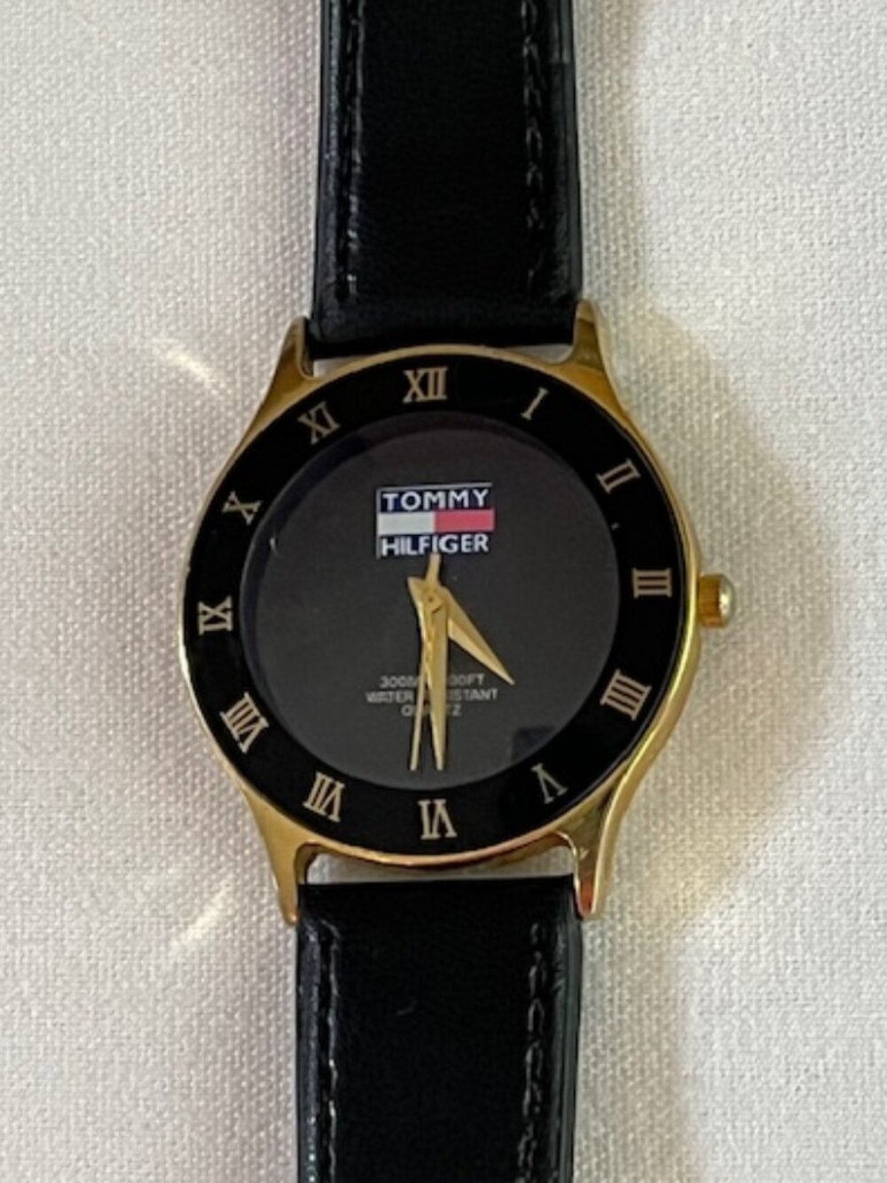 TOMMY HILFIGER | Black watch with gold-tone Roman numerals-NEW Battery